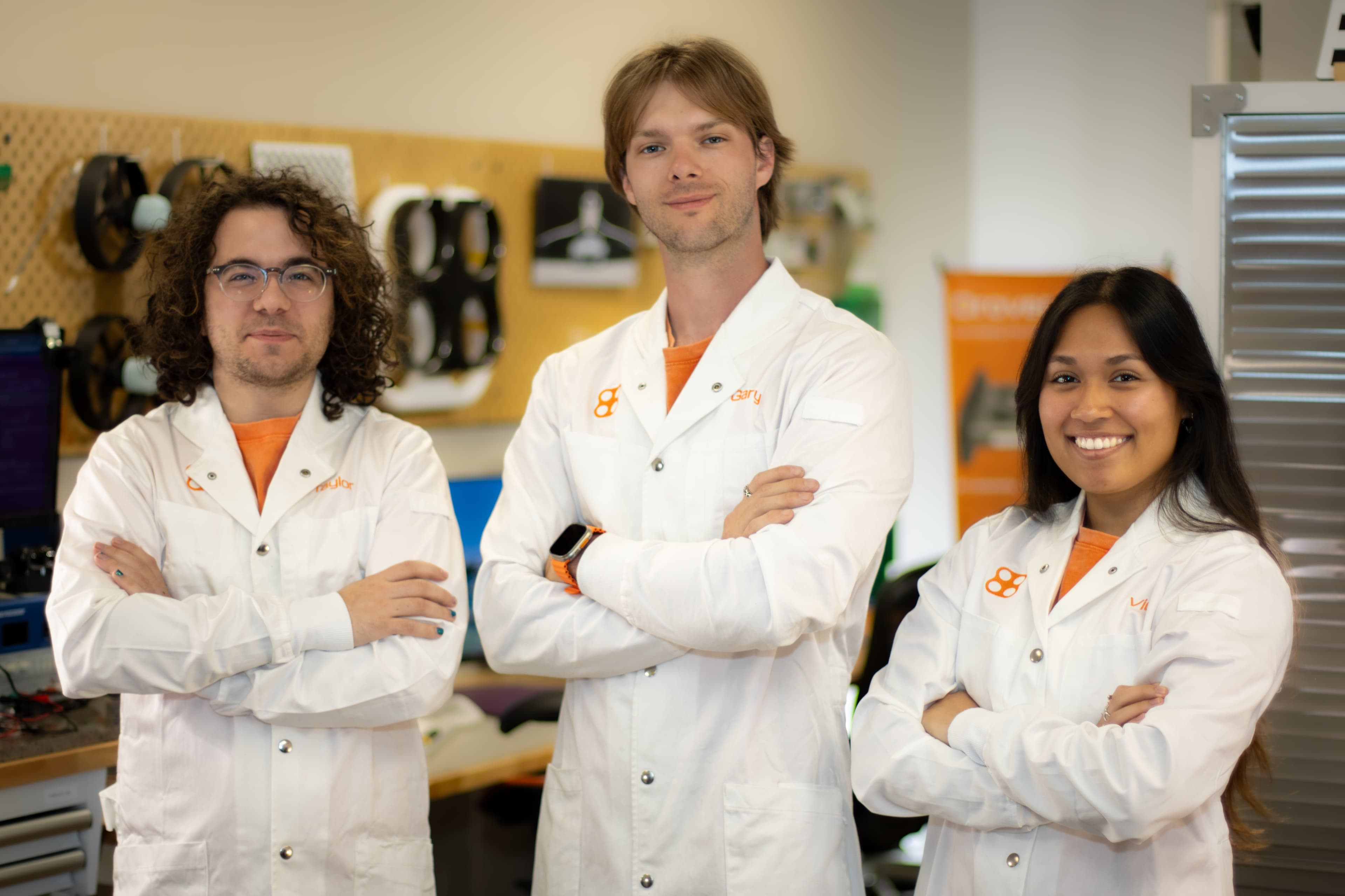 The three Drover Labs founders together in the workshop wearing white lab coats